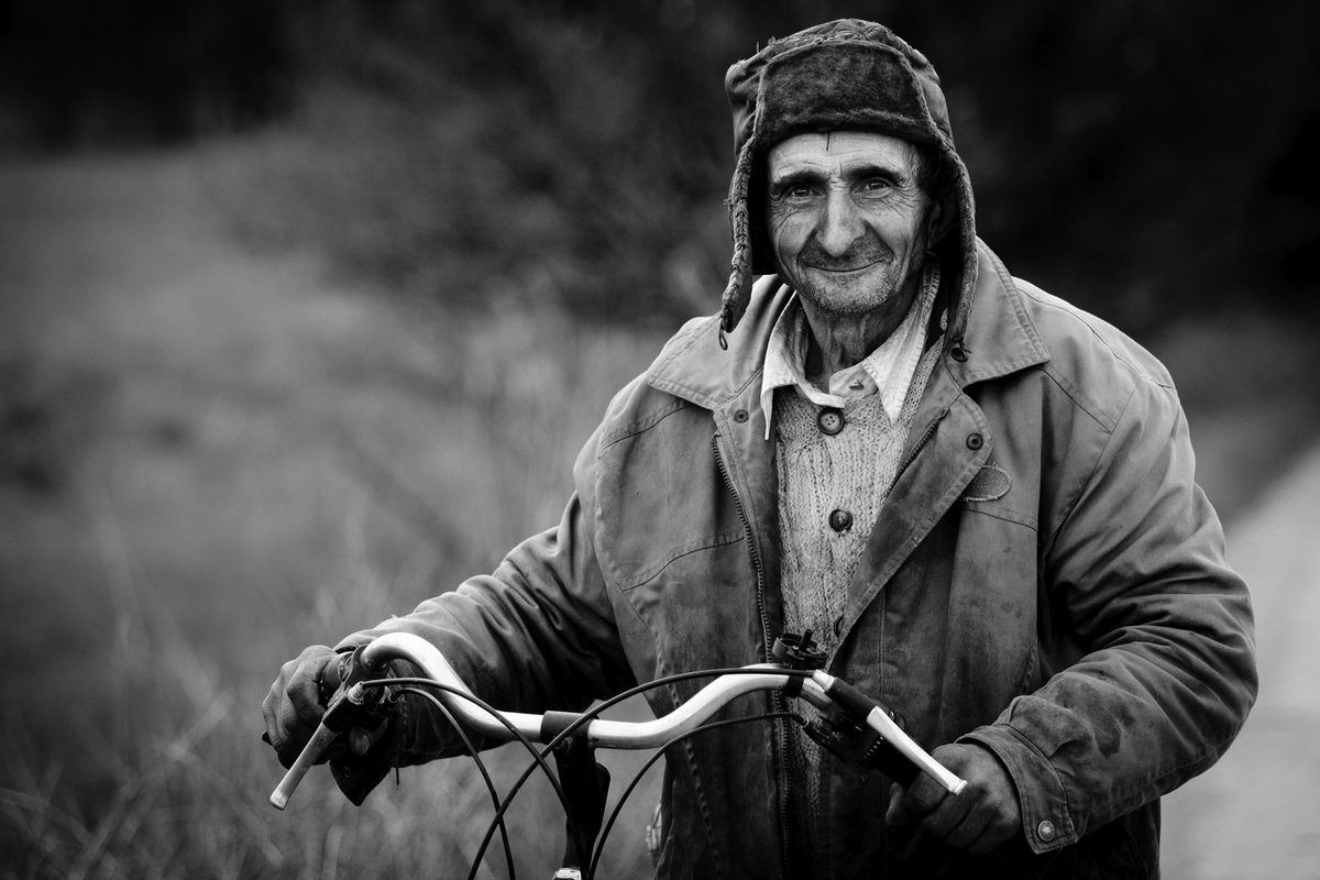 Man, old, bike, hat. Portrait photograph by Zoltan Plosz, finalist in the Shoot The Frame Portrait photography award, July 2012