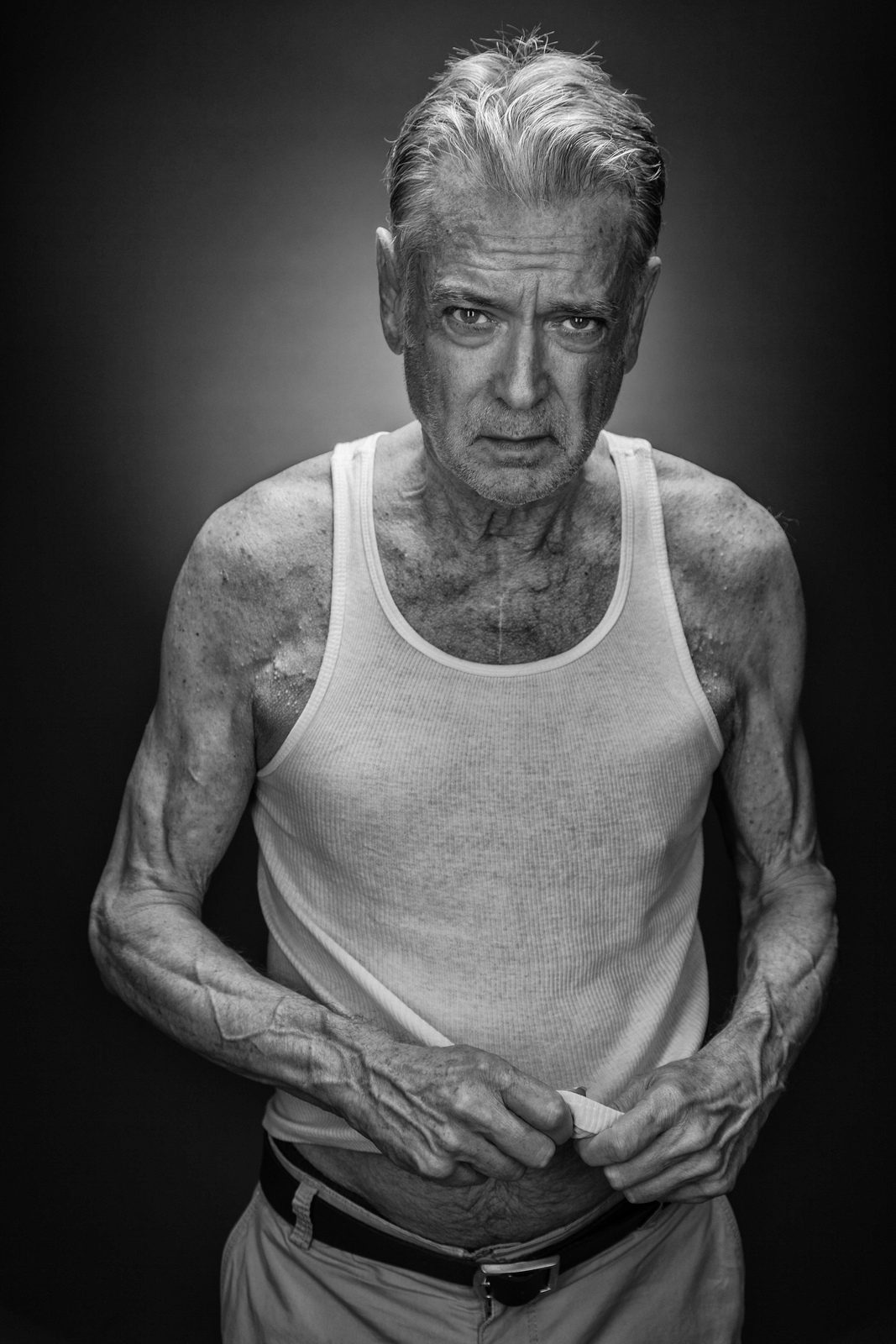 Man, white, sleeveless. Portrait photograph by Michael Schmidt, winner of the Shoot The Frame Portrait photography award, July 2012