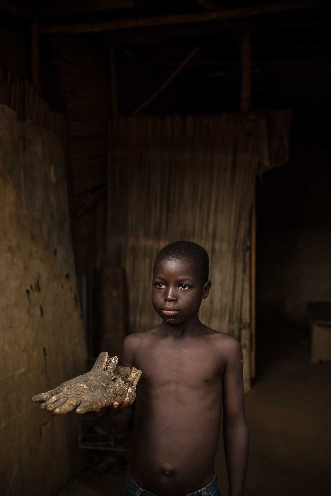 Boy, black, wood, feet. Portrait photograph by Cameron Karsten, finalist in the Shoot The Frame Portrait photography award, February 2014