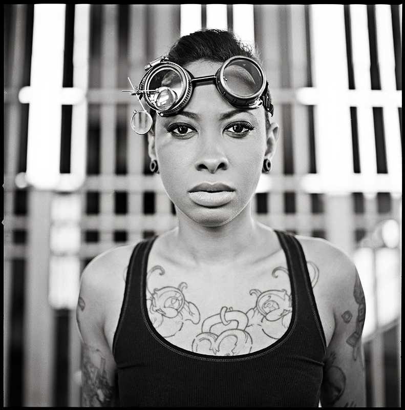 Woman, glasses, tattooe. Portrait photograph by Roza Sampolinska, finalist in the Shoot The Frame Portrait photography award, May 2014