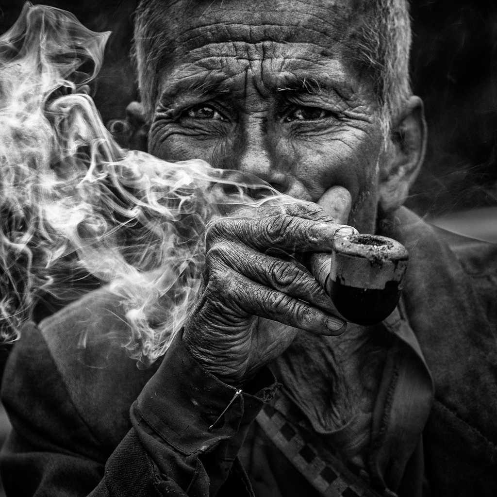 Man, smoke, cigarettes. Portrait photograph by Jayanta Roy, finalist in the Shoot The Frame Portrait photography award, June 2014