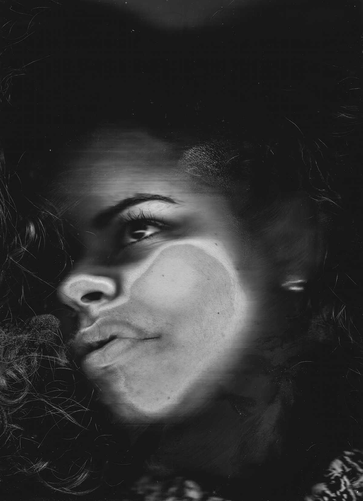 Wman, black, glass. Portrait photograph by Hugo Hentoff, finalist in the Shoot The Frame Portrait photography award, December 2014