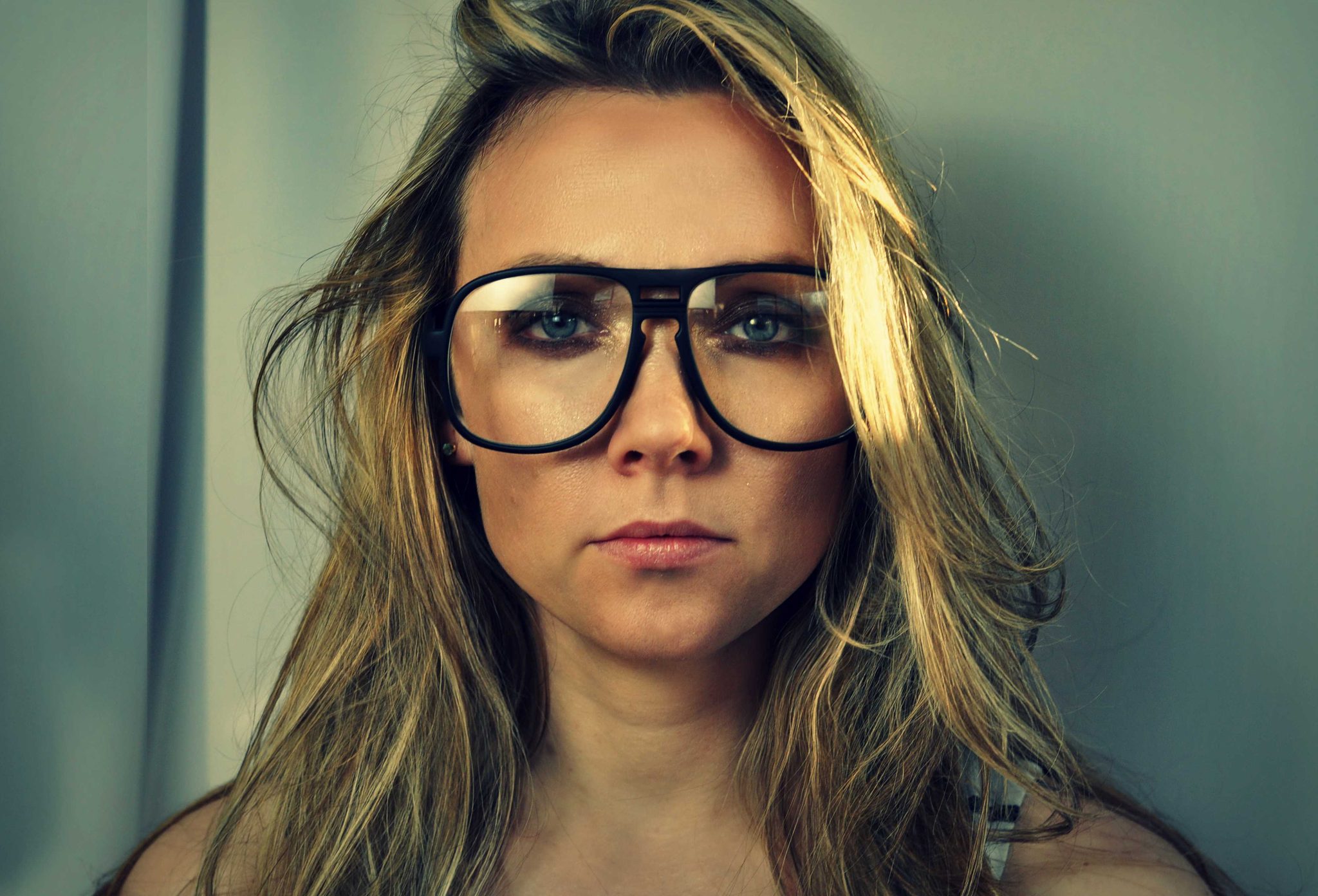 Woman, glasses, face. Portrait photograph by Monica Sylvester, finalist in the Shoot The Frame Portrait photography award, January 2016
