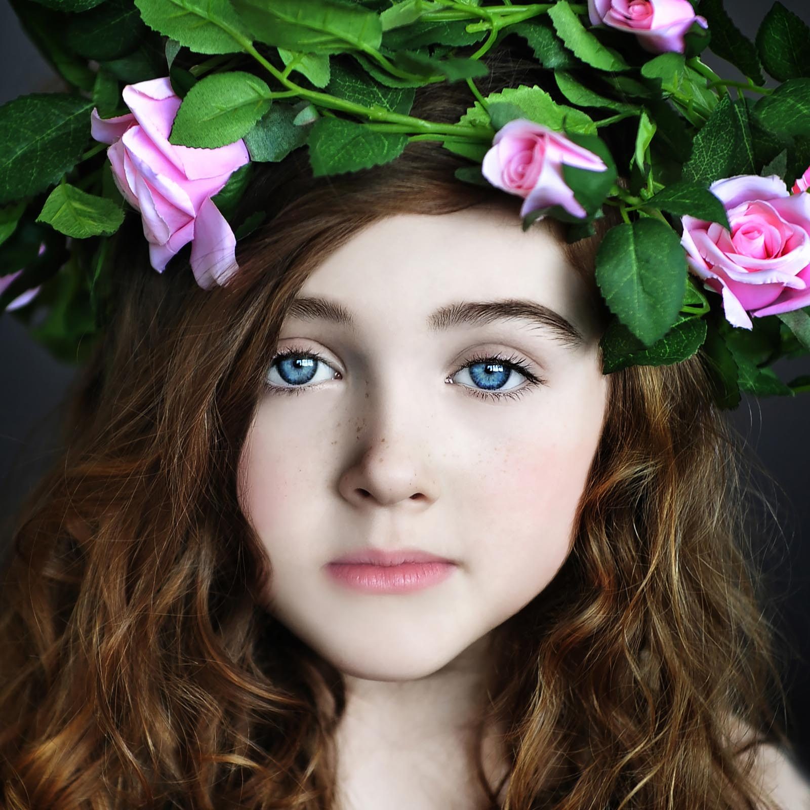 Girl, pink roses. Portrait photograph by Anne Higgs, finalist in the Shoot The Frame Portrait photography award, May 2016