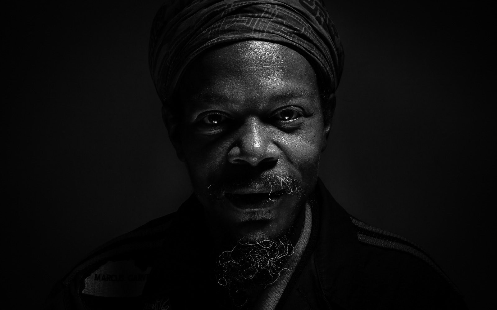 Dim, man, dark, beard. Portrait photograph by Kennesha Walker, finalist in the Shoot The Frame Portrait photography award, May 2016