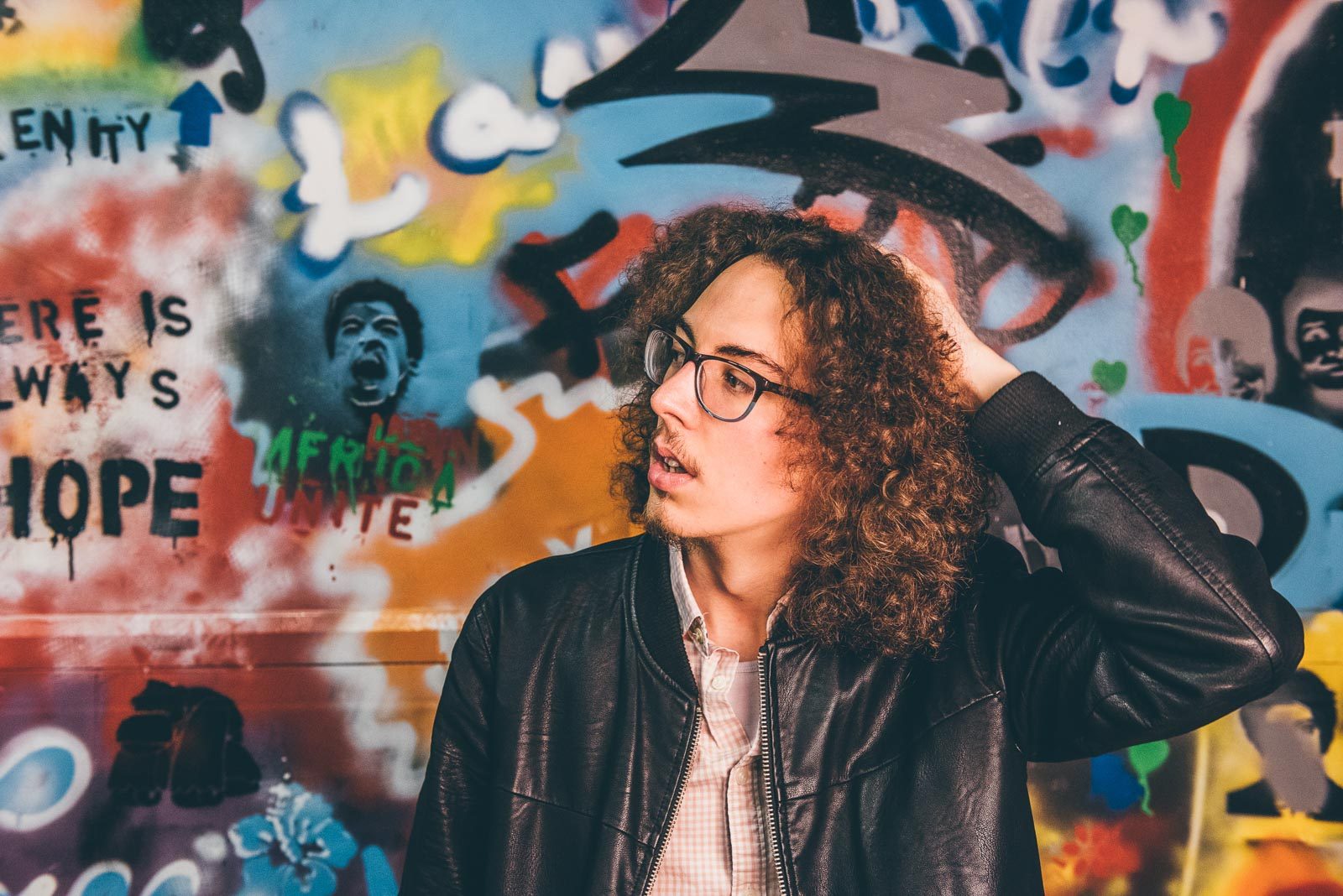 Man, glasses, curly, paint. Portrait photograph by Luke Taylor, finalist in the Shoot The Frame Portrait photography award, June 2016