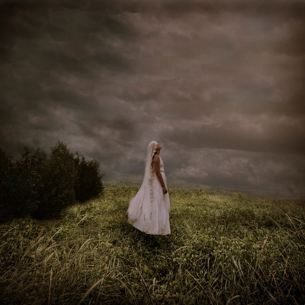 Huma, grass, clouds. Portrait photograph by Cheryl Clegg, finalist in the Shoot The Frame Portrait photography award, May 2018