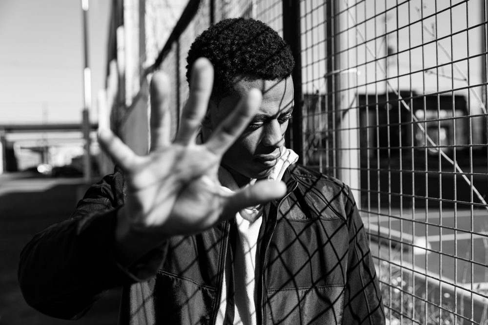 Fence, human, jacket. Portrait photograph by David Griffiths, finalist in the Shoot The Frame Portrait photography award, May 2018