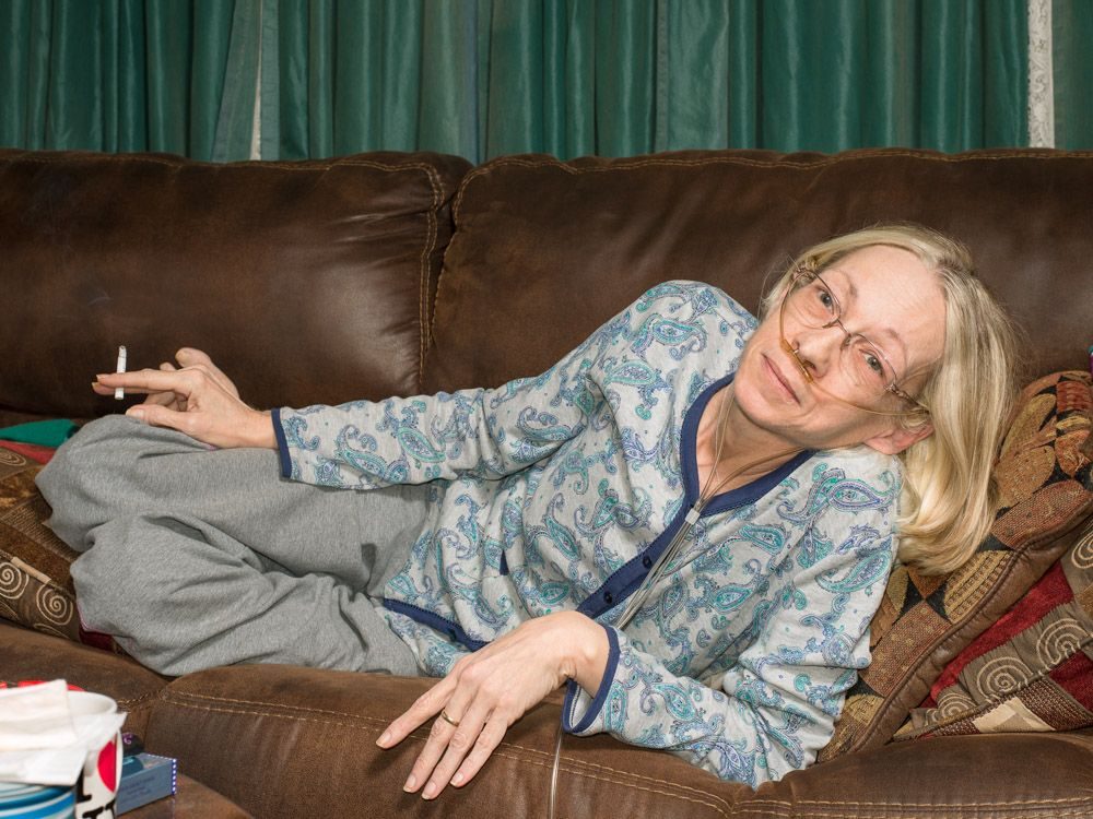Cigarette, sofa, woman. Portrait photograph by Michael Young, finalist in the Shoot The Frame Portrait photography award, January 2019