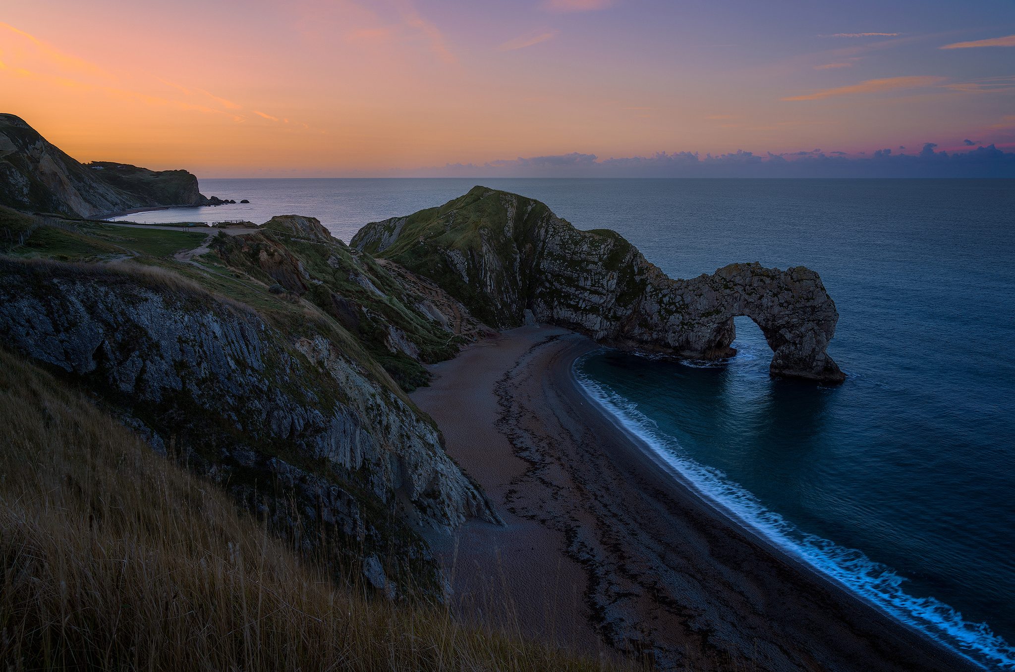 Sunrise Durdle Door, Durdle Door, Littledown, Wareham BH20 5PU, UK. Landscape photograph by Tim Burgess, finalist in the Shoot The Frame Landscape photography award, February 2024